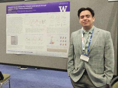 Leonardo Diaz stands in front of a research poster